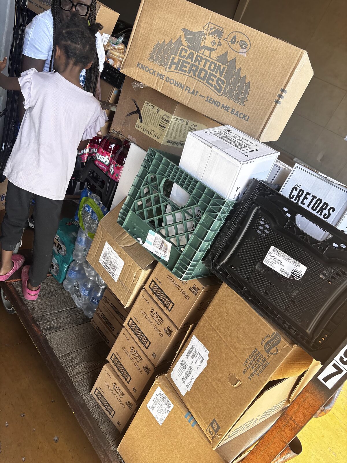 A young child helping at a Manna Impact distribution event